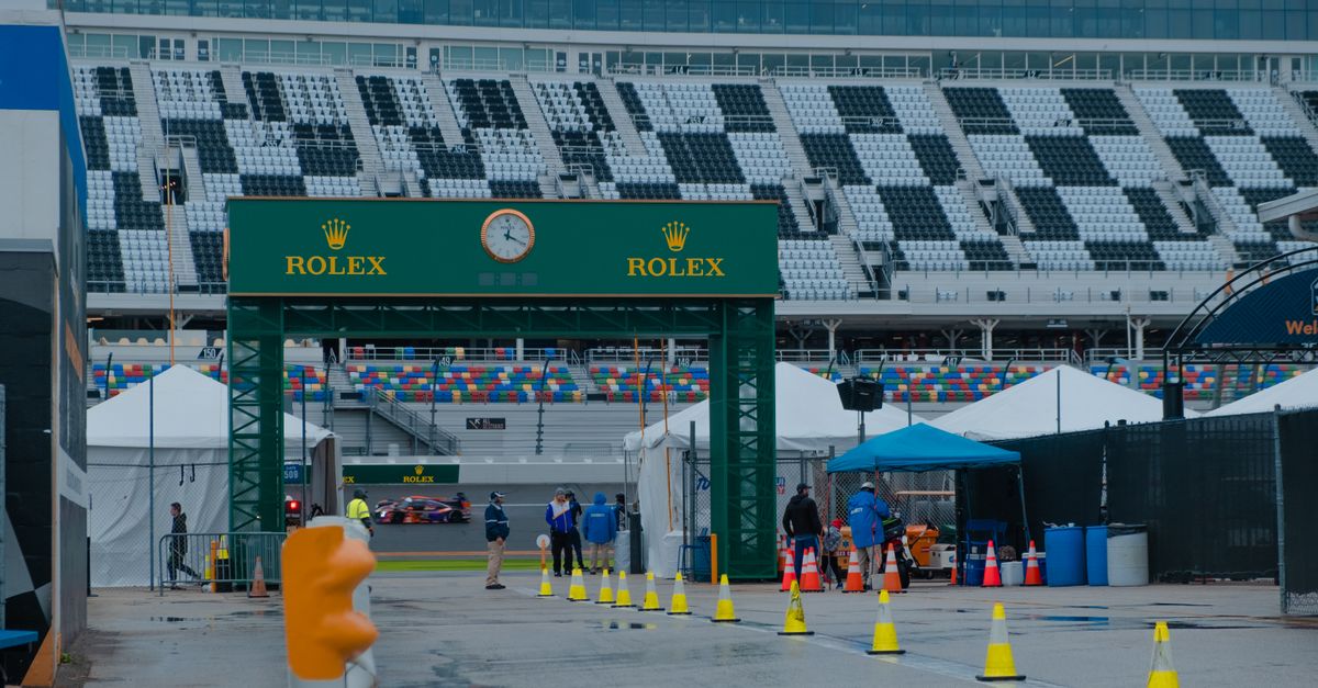 Exciting scene at Daytona Speedway with Rolex sponsorship during a race event.